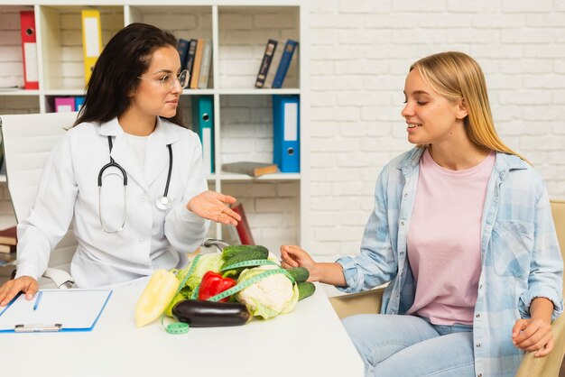 Medium shot doctor talking to patient about vegetables 