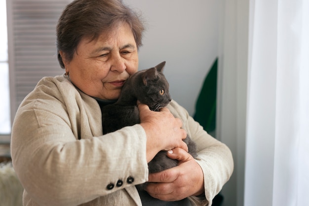 Medium shot elderly woman with cat