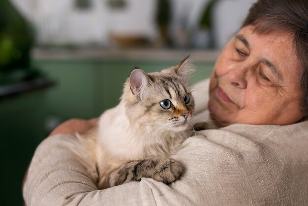 Medium shot elderly woman with cat