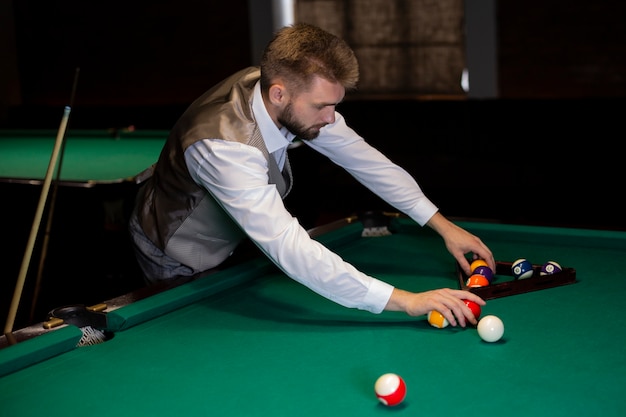 Free Photo medium shot elegant man arranging pool balls