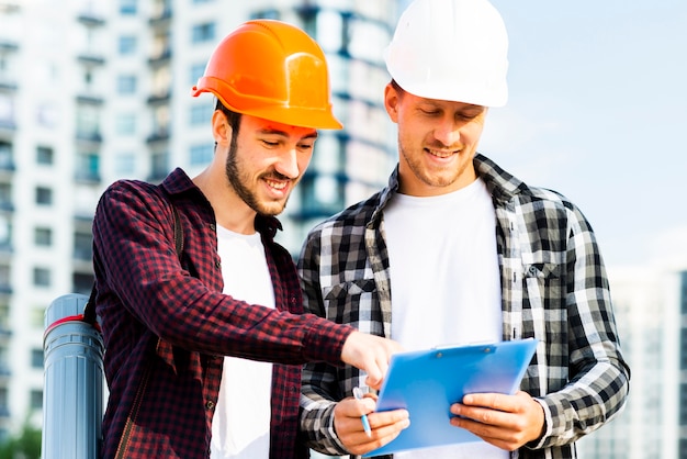 Free Photo medium shot of engineer and architect  looking at clipboard