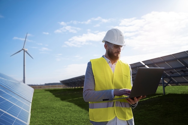 Free Photo medium shot engineer holding laptop