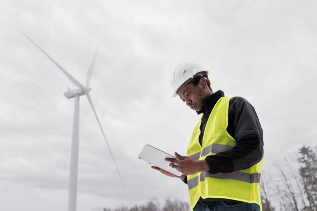 Medium shot engineer holding tablet