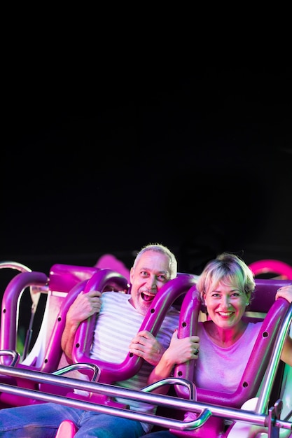 Free photo medium shot excited people in amusement ride