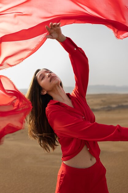 Medium shot expressive woman throwing red scarf