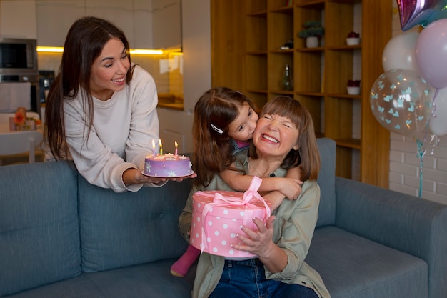 Medium shot family celebratig with cake