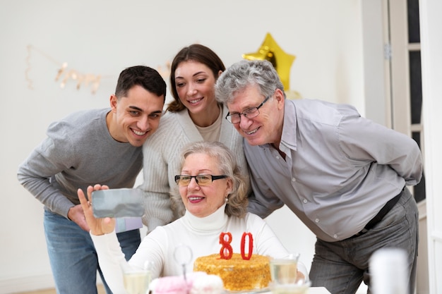 Medium shot family celebrating woman's birthday