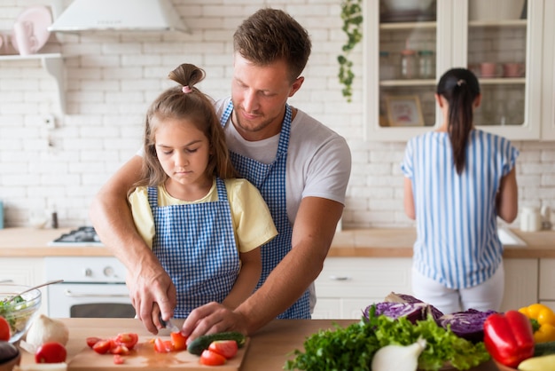 Medium shot family cooking together