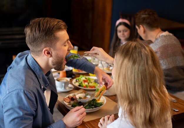 Medium shot family eating together