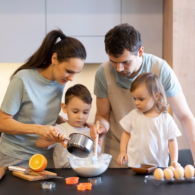 Medium shot family making dough