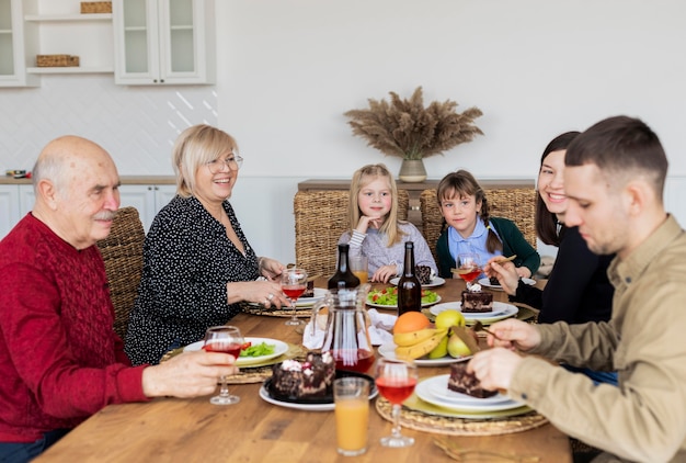 Medium shot family members eating