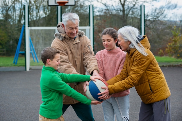 Medium shot family members playing with ball