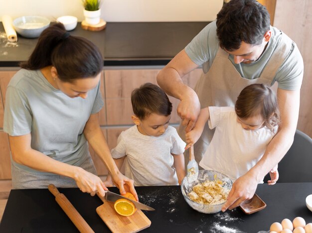 Medium shot family preparing desert