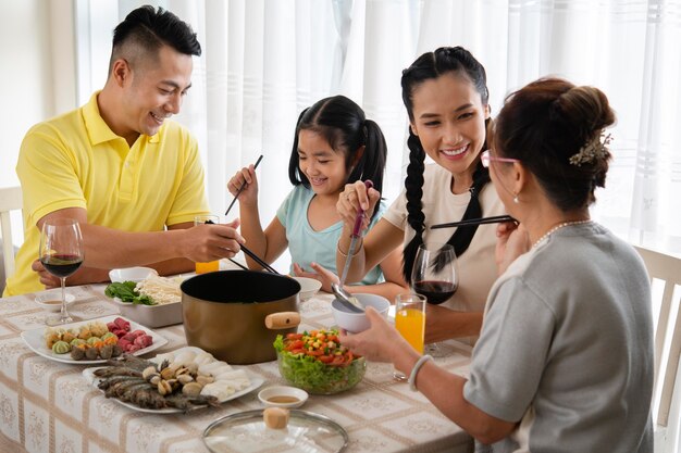 Medium shot family sitting at table