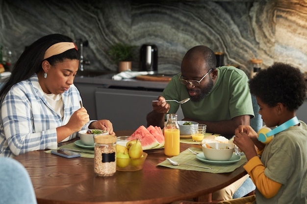 Medium shot family sitting at table