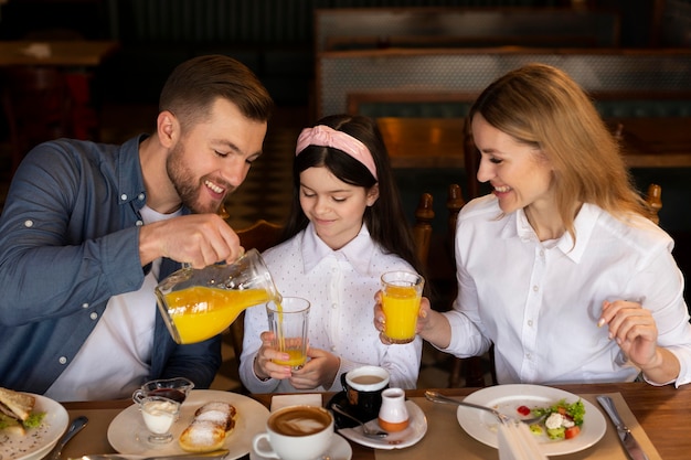 Medium shot family at table