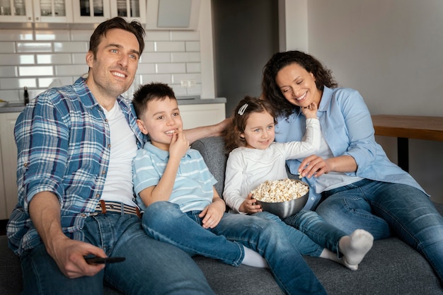 Free photo medium shot family watching television