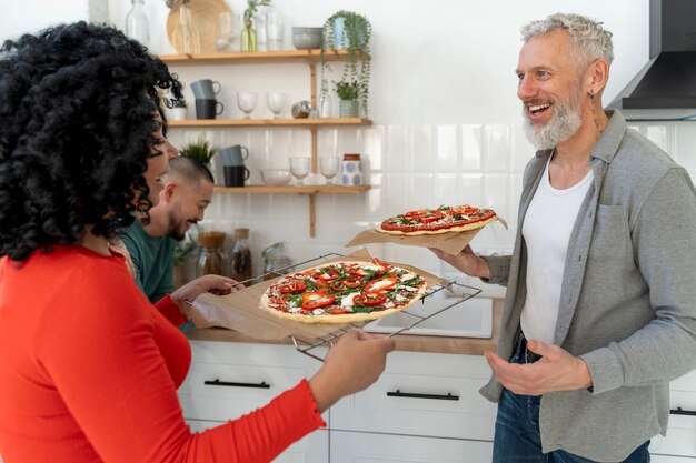 Medium shot family with delicious pizza