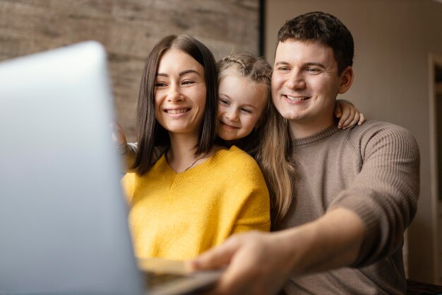 Medium shot family with laptop