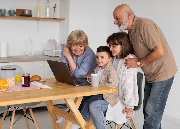 Medium shot family with laptop