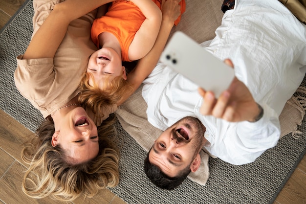 Medium shot family with smartphone