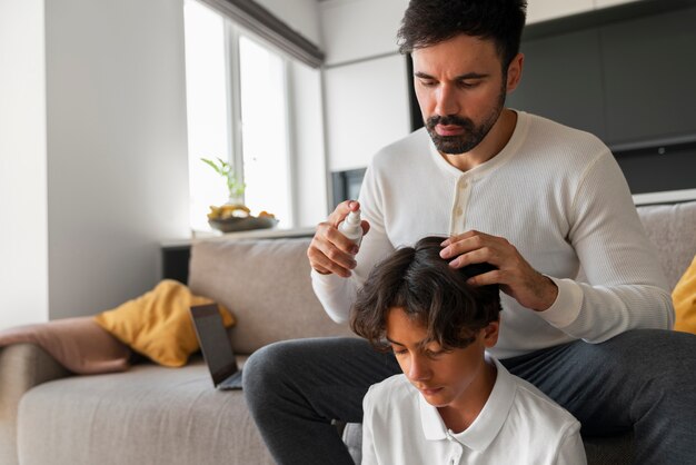 Medium shot father applying lice treatment