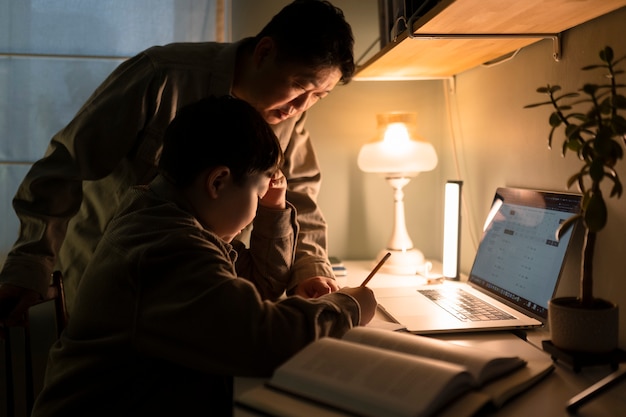 Free Photo medium shot father helping kid with homework