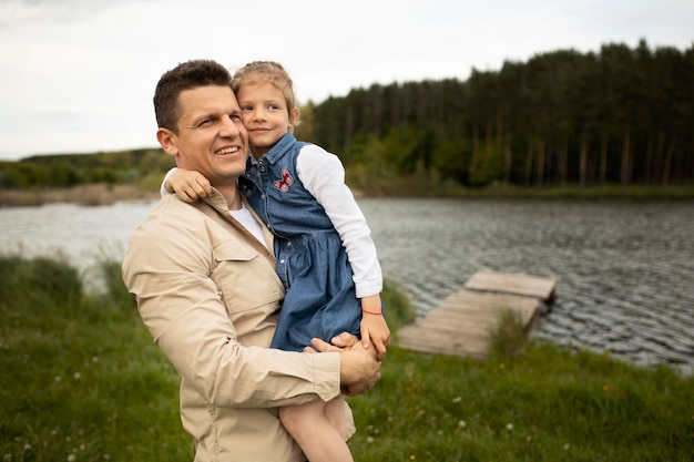 Free photo medium shot father holding child