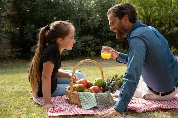 Medium shot father and kid at picnic