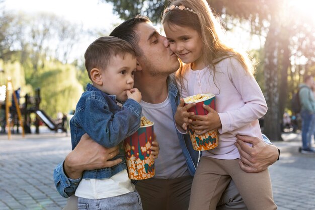 Medium shot father and kids in park