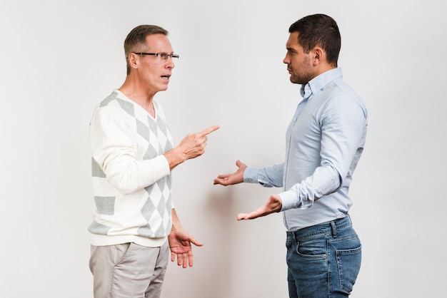 Free Photo medium shot of father and son arguing