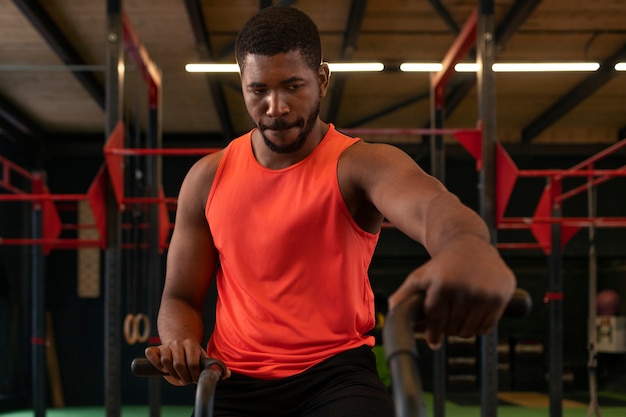 Medium shot fit man at gym