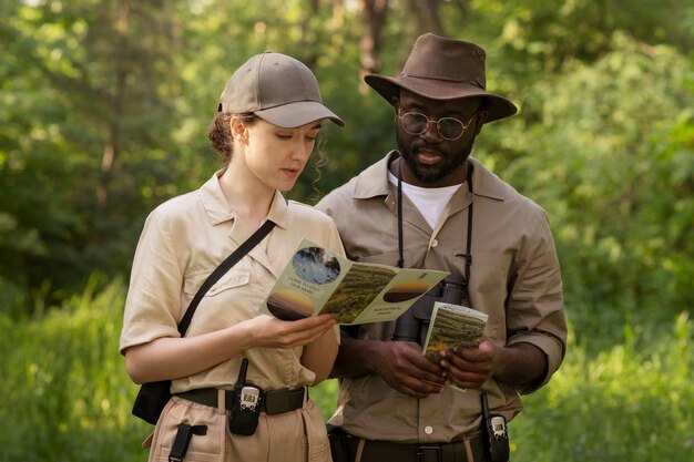 Medium shot forest wardens with brochure