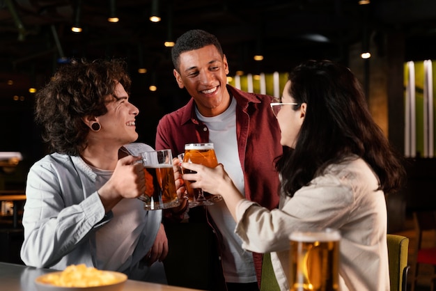 Medium shot friends chatting in pub