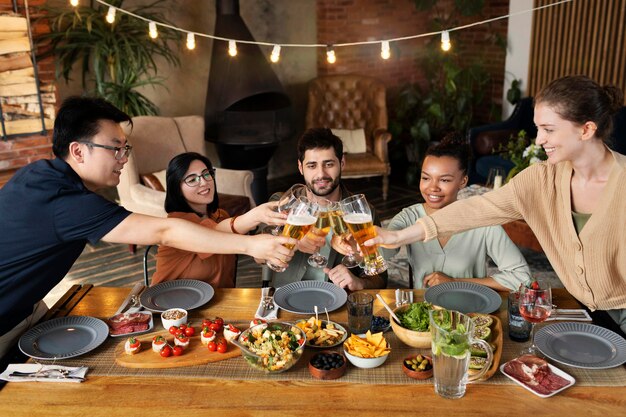 Medium shot friends clinking glasses