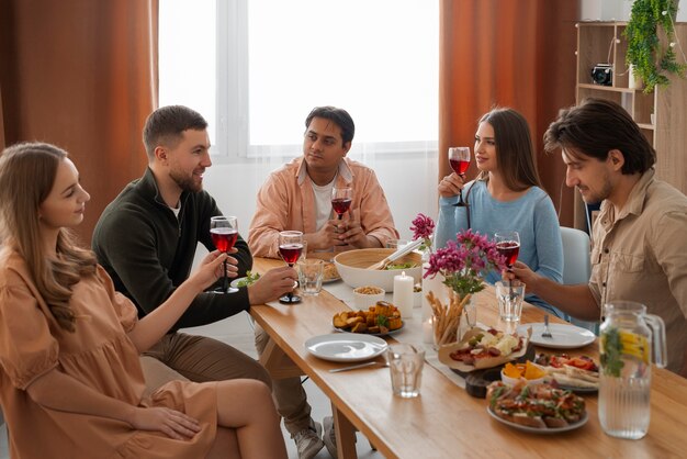 Medium shot friends at dinner party