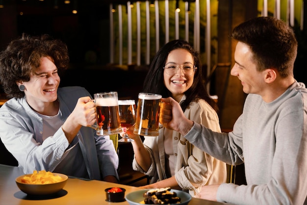 Medium shot friends holding beer mugs