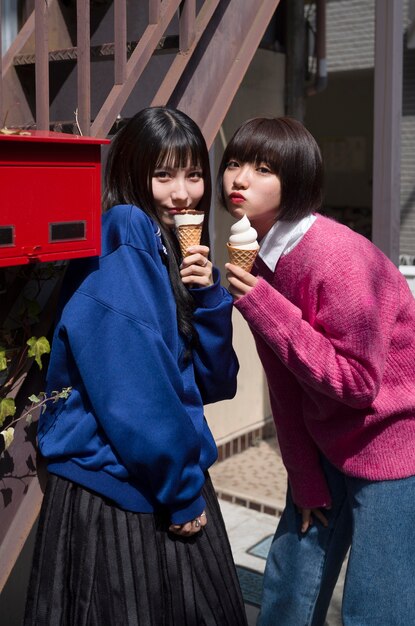 Medium shot friends posing with ice cream