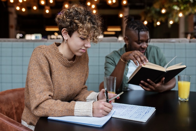 Medium shot friends sitting in coffee shop