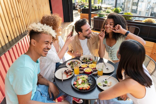 Medium shot friends sitting at table