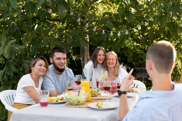 Medium shot friends sitting at table