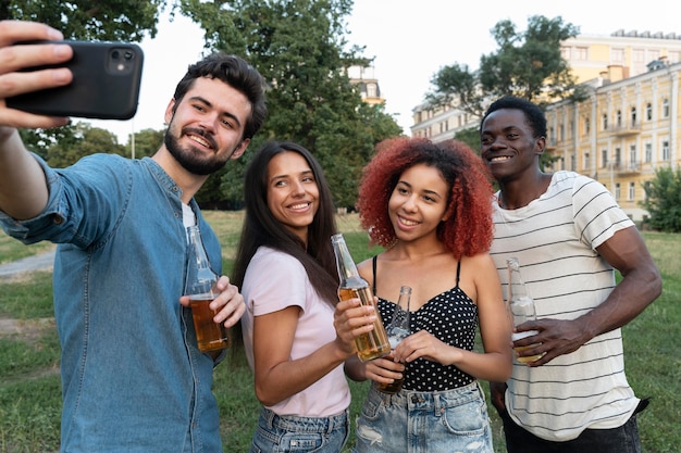 Medium shot friends taking selfie