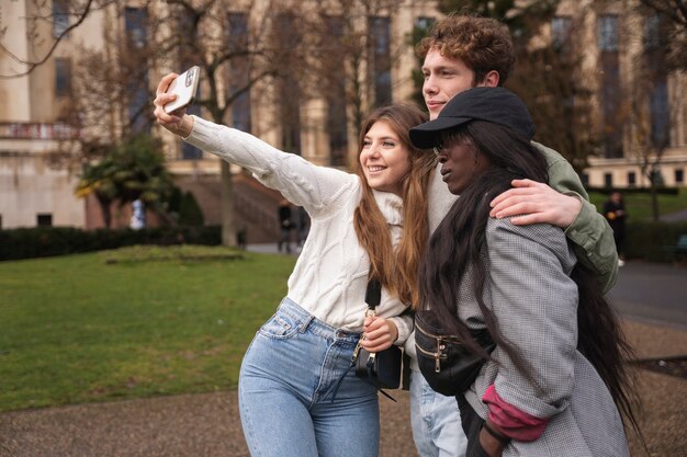 Medium shot friends taking selfie