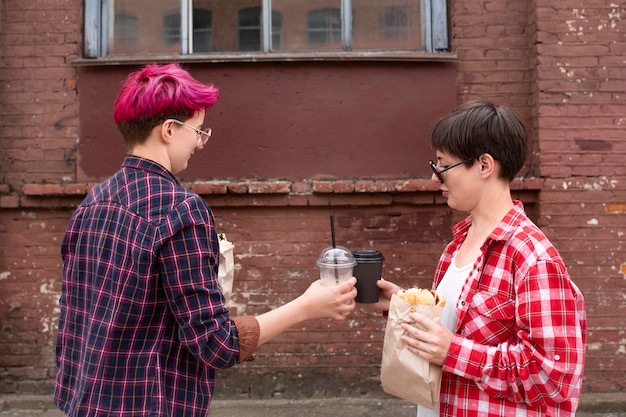 Medium shot friends with coffee cups