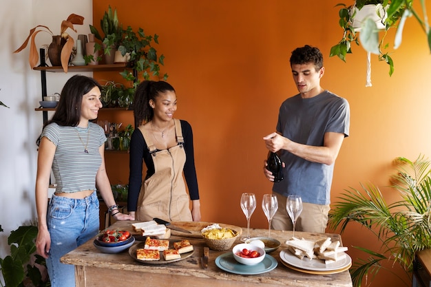 Medium shot friends with delicious food indoors