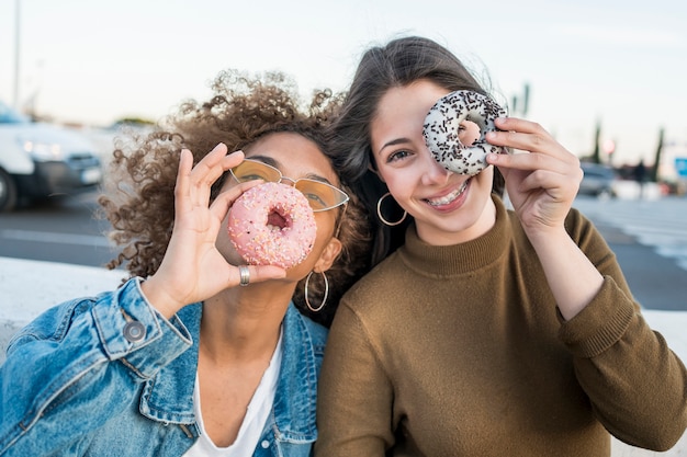 Medium shot friends with doughnuts