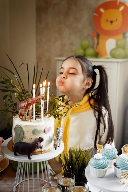 Medium shot girl blowing candles