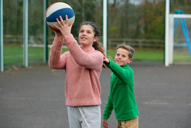 Medium shot girl and boy playing together