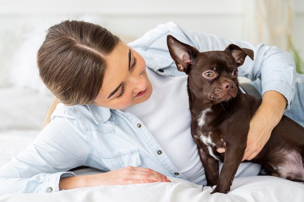 Medium shot girl and dog in bed