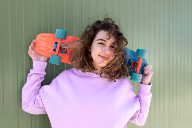 Medium shot girl holding skateboard